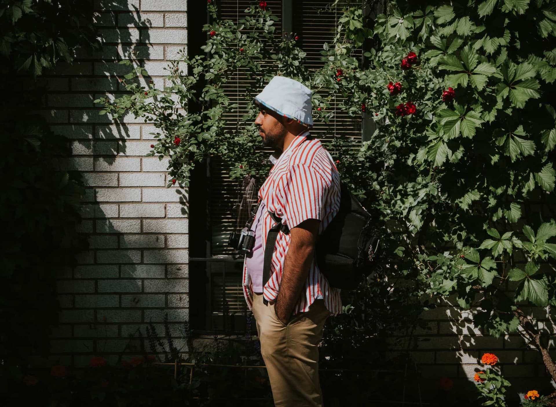 A side view of a man wearing a bucket hat